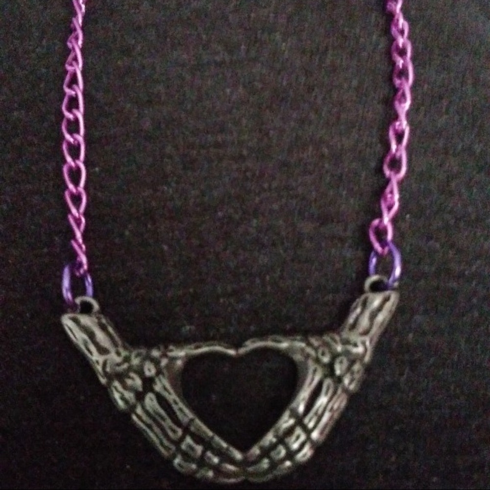 Pink chain skeleton hands heart necklace